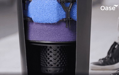 OASE FiltoClear sponges shown mid-squeeze.