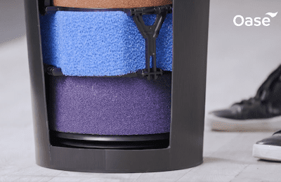 The internal filter sponges are shown stacked in the squeezing mechanism with no pressure being exerted.